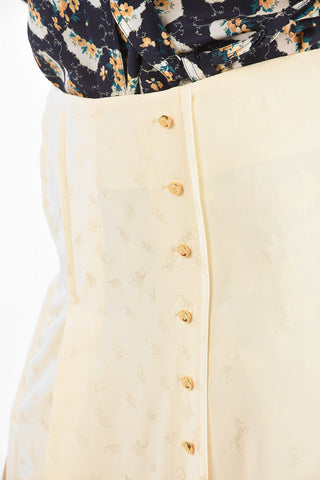 silk split-back hem and double split-front hem skirt with golden buttons