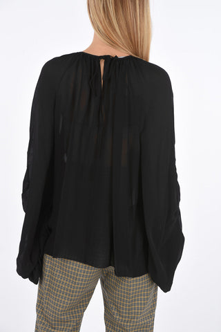 Blusa con manica drappeggiata