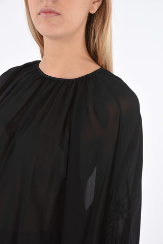 Blusa con manica drappeggiata