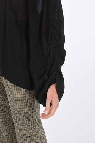 Blusa con manica drappeggiata