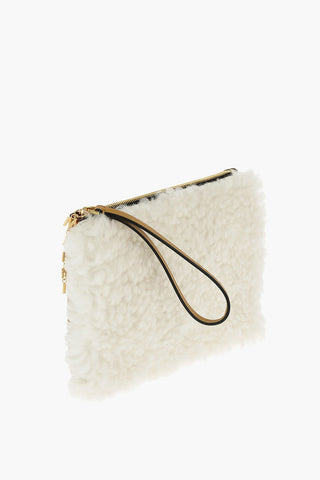 shearling clutch with logoed charm
