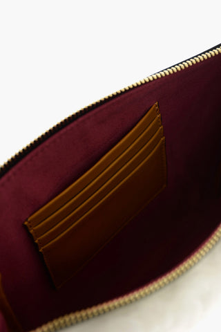 shearling clutch with logoed charm