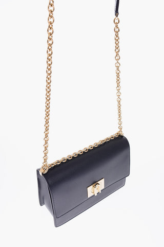 textured leather crossbody bag with chain shoulder strap