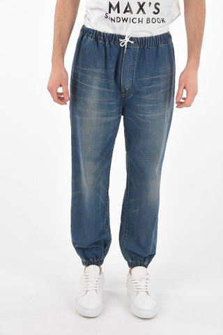 Mid wash jeans with drawstrings and cuffed ankles