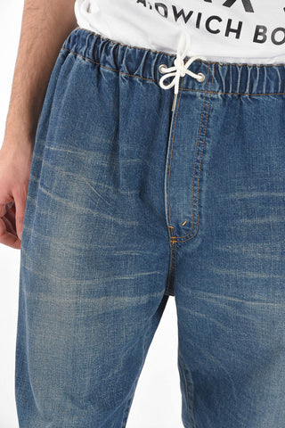 Mid wash jeans with drawstrings and cuffed ankles