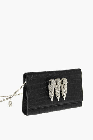 crocodile effect leather clutch decorated with claw rings