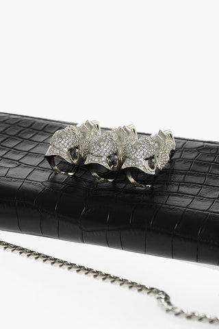 crocodile effect leather clutch decorated with claw rings