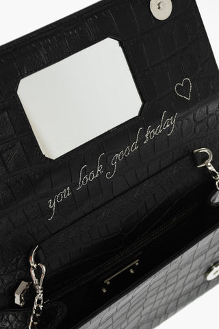 crocodile effect leather clutch decorated with claw rings