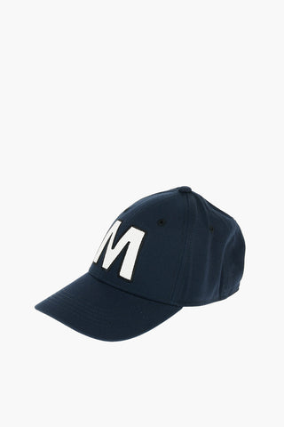 Cotton gabardine cap with contrast embroidered “M” patch on the front