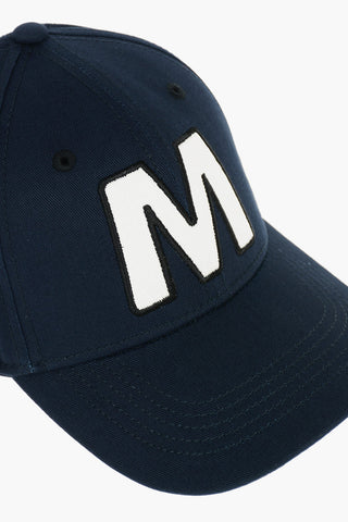 Cotton gabardine cap with contrast embroidered “M” patch on the front