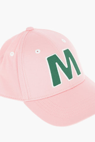 Cotton gabardine cap with contrast embroidered “M” patch on the front