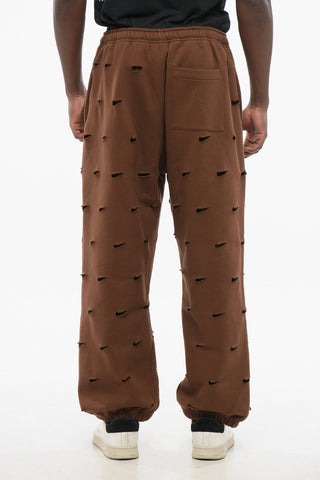 JACQUEMUS Solid Color SWOOSH Joggers with All-Over Cut-Out Details