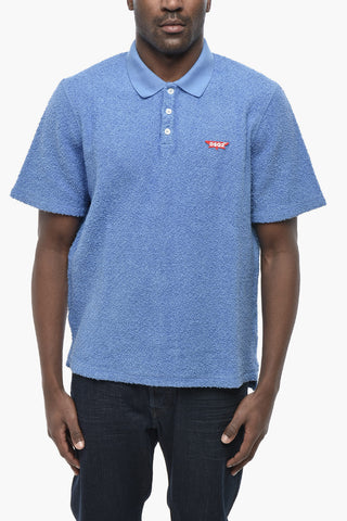 Polo aus Baumwollfrottee mit Logo-Pin