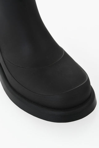 Leather and rubber boots with logo strap